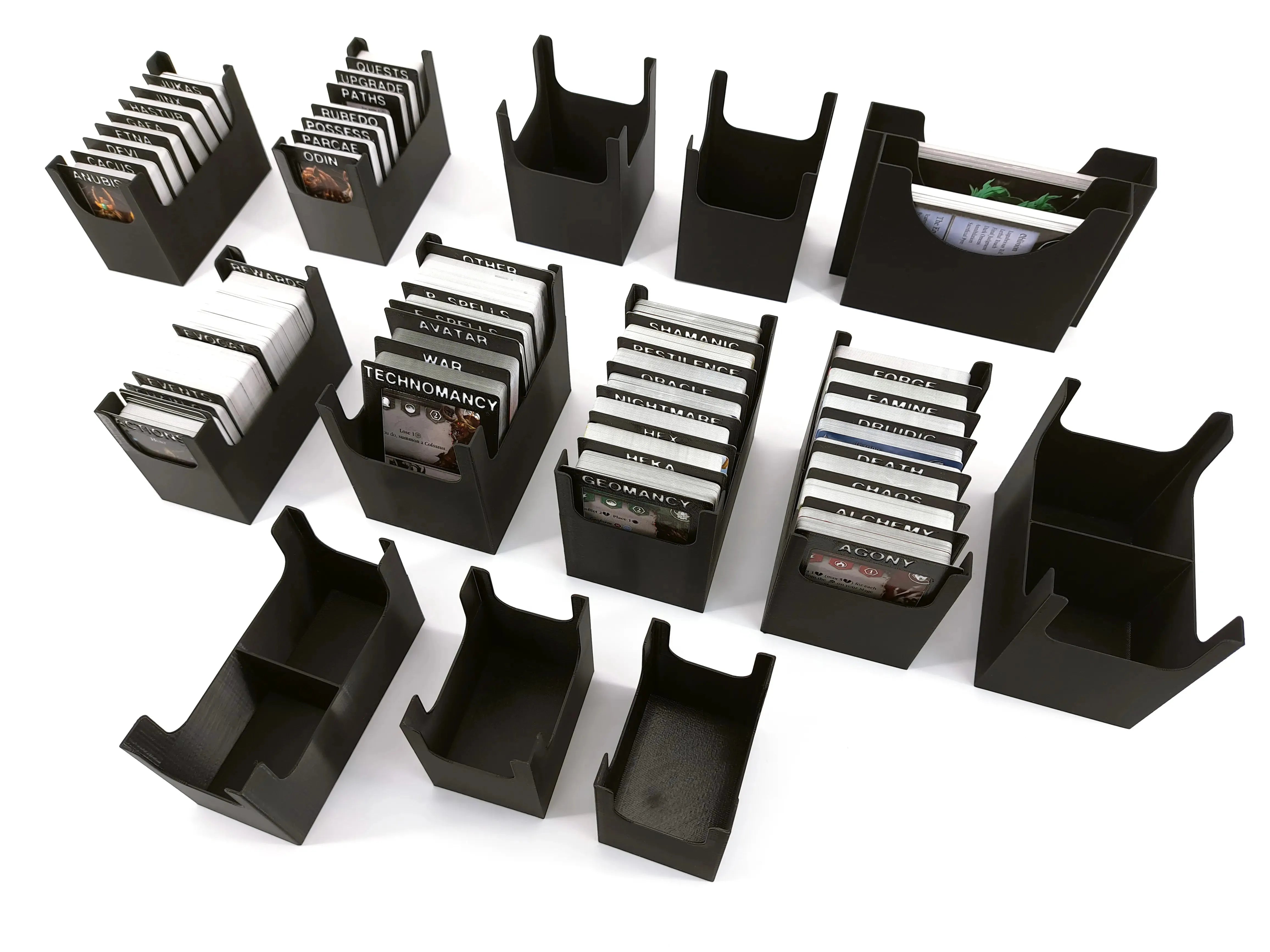 Set of modular 3D-printed card holder inserts by Tinkering Paws, shown with various card decks and empty holders. Designed for organizing board game cards. Digital STL files only, no physical product included.