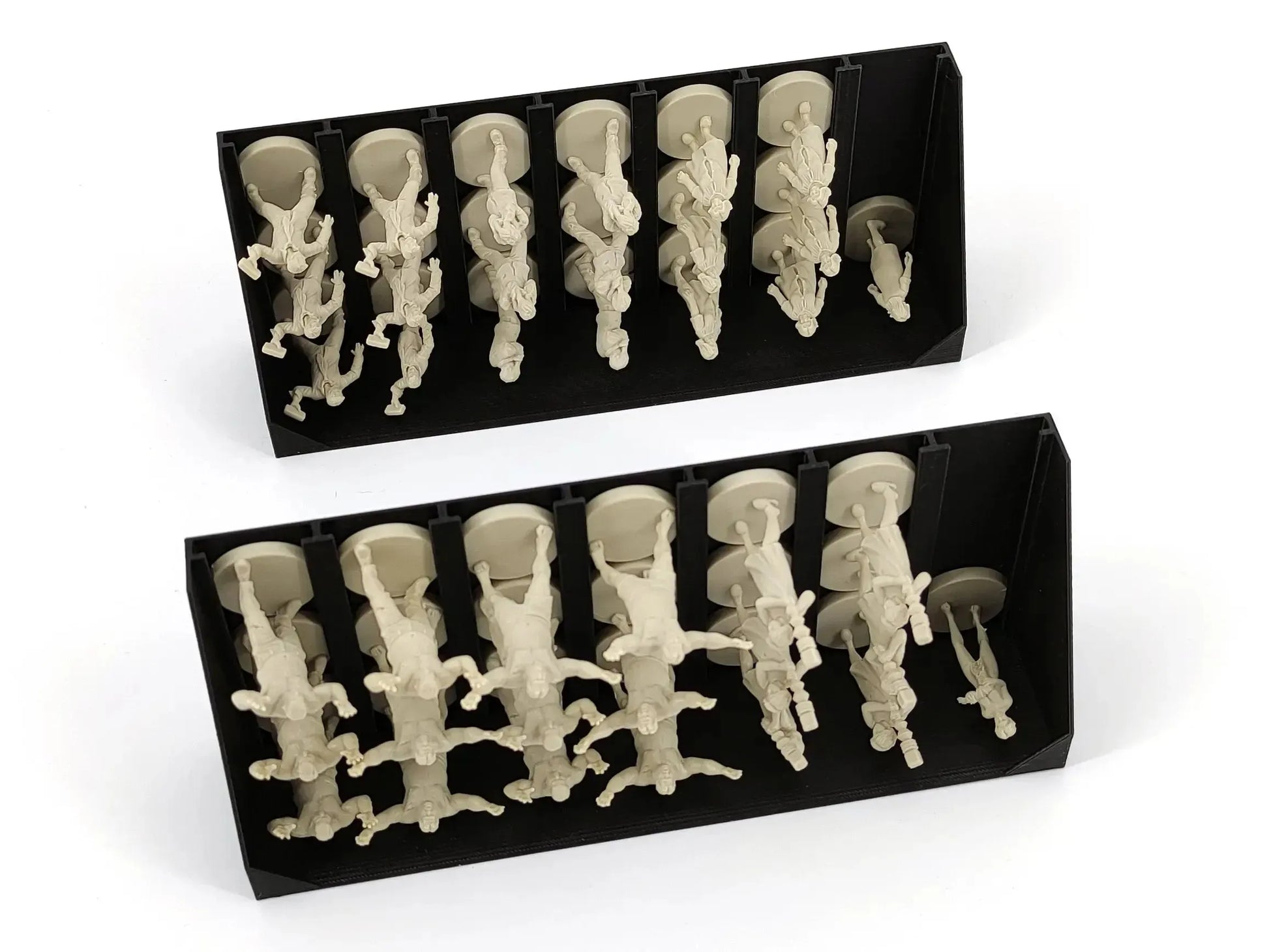 Two black vertical storage trays holding various grey, tan, and red plastic miniatures for the Night of the Living Dead board game.