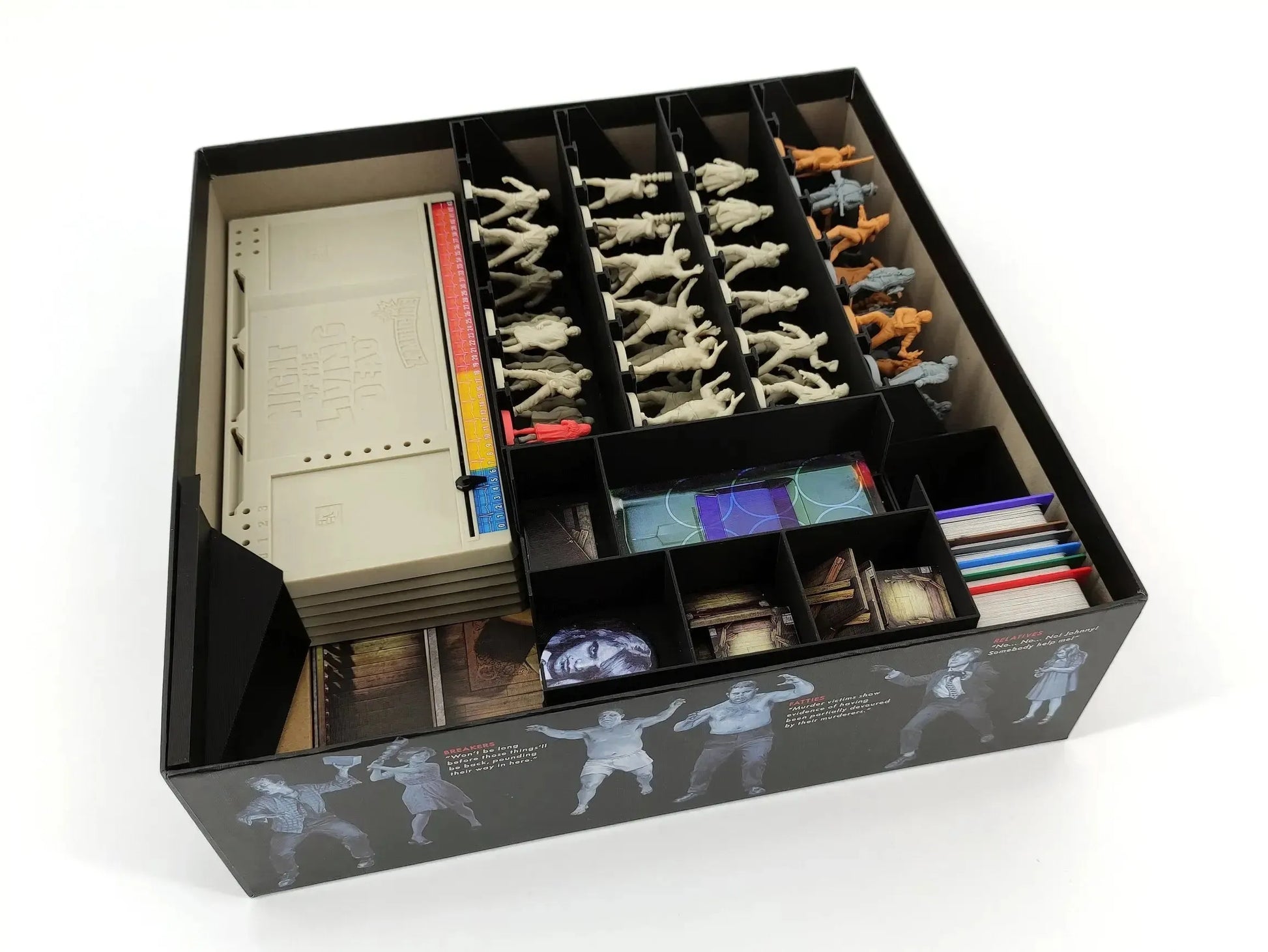 The Night of the Living Dead board game box perfectly organized with a custom black insert system holding all miniatures and cards securely.