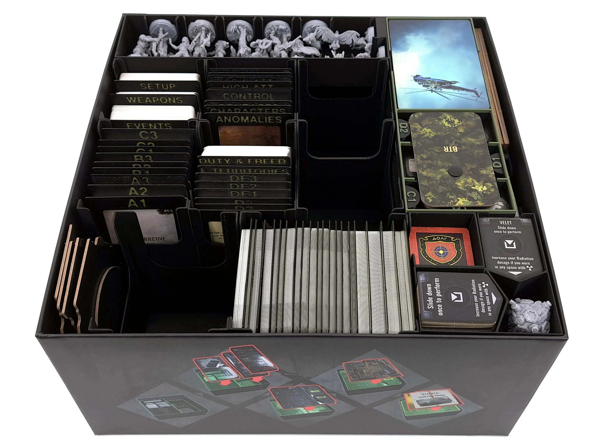 Top-down view of the fully loaded STALKER: The Board Game Organizer inside the core box, showing labeled card holders, component sections, and the main card tray.